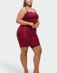 Woman wearing a burgundy romper on a white background