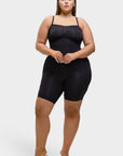 Woman wearing a black bodysuit on a white background