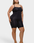 Woman wearing a black bodysuit on a white background
