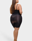 Woman wearing a black sheer romper on a white background