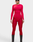 Person wearing a bright red bodysuit and black boots on a white background
