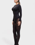 Woman wearing a black bodysuit and tights on a white background