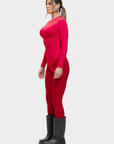 Woman wearing a red outfit with black boots on a white background