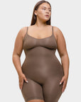 Woman wearing a brown shapewear bodysuit on a white background