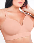 Beige bra worn by a model on a white background
