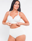 Woman wearing a white swimsuit against a plain background