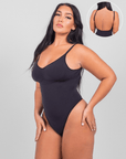 Woman wearing a black swimsuit with a close-up inset on a gray background