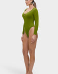 Woman wearing a green bodysuit on a white background