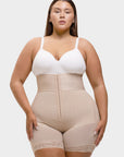 Woman wearing a white bra and beige shapewear on a white background