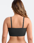 Black sports bra worn by a person on a light gray background